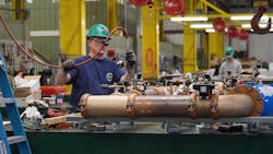 An E. M. Duggan technician working in the company plumbing prefab shop. An E. M. Duggan technician working in the company plumbing prefab shop.