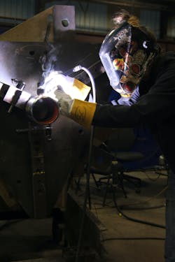 Conway at work in the company's prefab shop. Conway at work in the company's prefab shop.