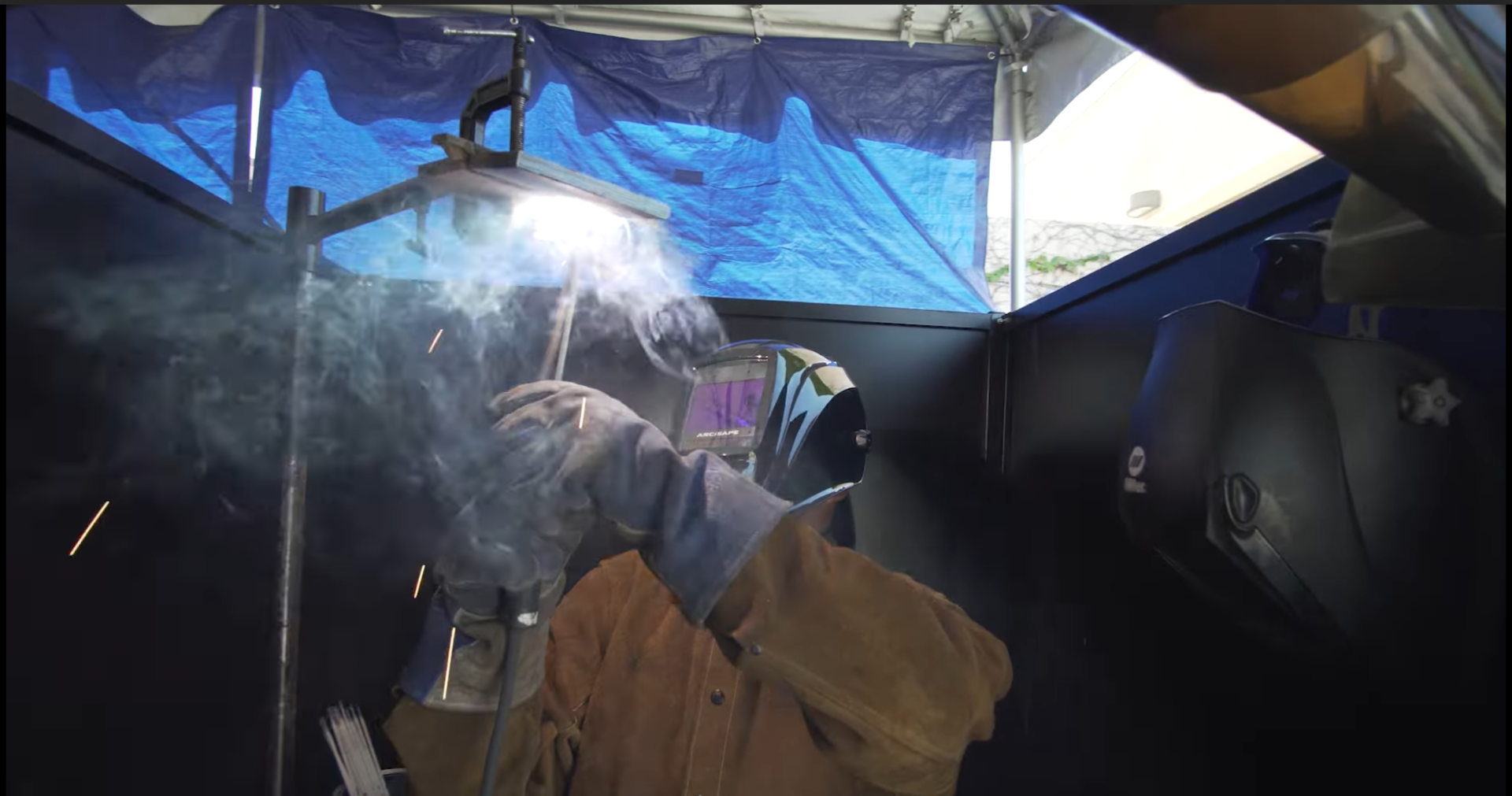 A trade school student practices welding in a YouTube video highlighting the Harbor Freight Tools for Schools program.
