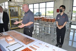 Clarence McKenzie in the stamping department. Clarence McKenzie in the stamping department.