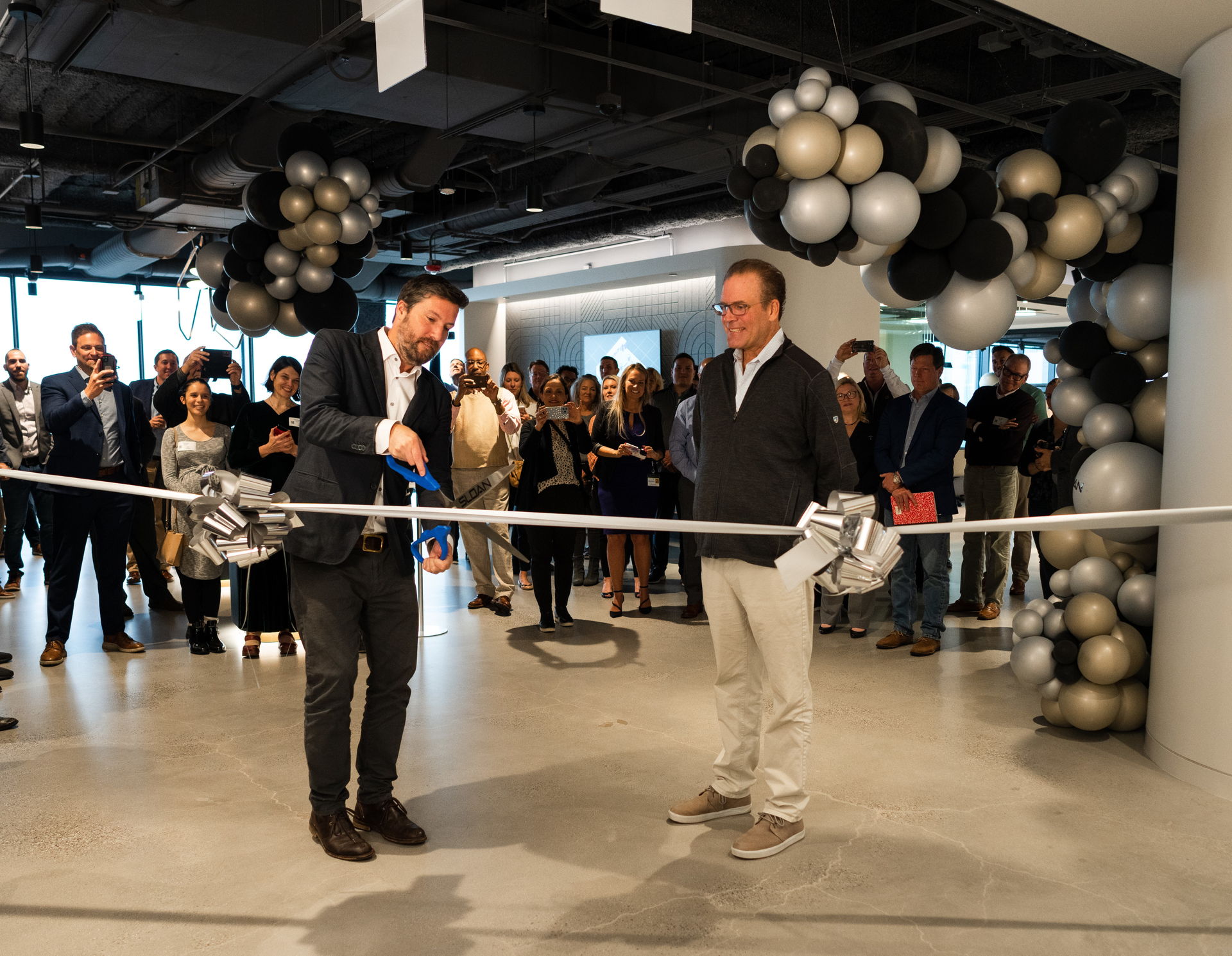 Sloan co-presidents and CEOs Graham Allen (left) and Kirk Allen (right) at the ribbon-cutting for the new offices.