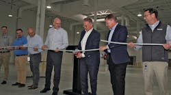 Michael Rauterkus, president and CEO, Uponor Group, (center) joins business leaders as he cuts the ceremonial PEX-a pipe to mark the opening of the company&rsquo;s $5.5 million, 25,000 sq. ft. expansion in Hutchinson, Minn.