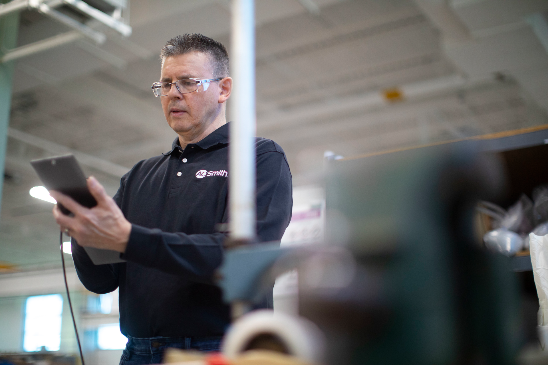 A quality control worker on the line at an A. O. Smith manufacturing facility.