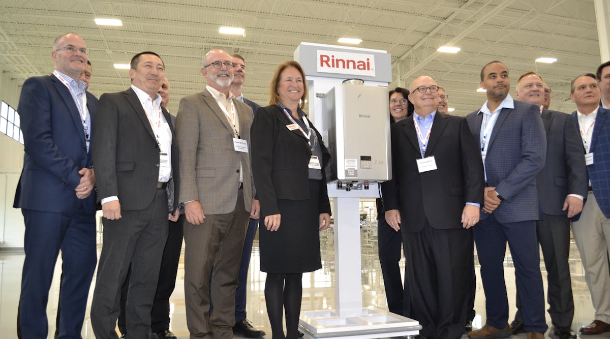 Rinnai executives gathered around the first tankless unit produced at the company&apos;s new Griffin, GA facility.