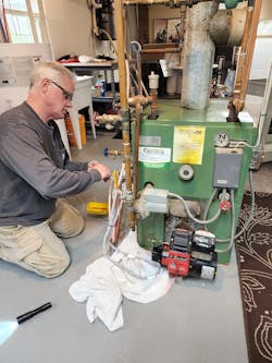 The original oil-fired boiler being uninstalled. The original oil-fired boiler being uninstalled.