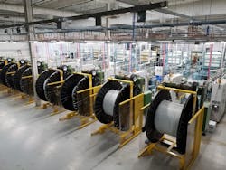 Spools of PEX tubing being wound on the Uponor factory floor. Spools of PEX tubing being wound on the Uponor factory floor.