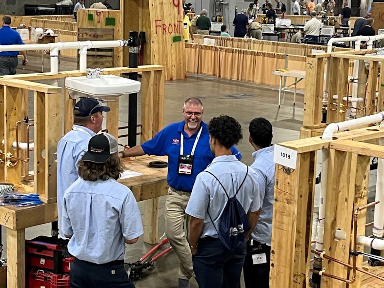 PHCC member and SkillsUSA judge Larry Shoemaker from Deluxe Plumbing and Heating in Bethlehem, PA talks with contestants.