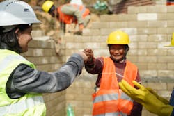 New homeowner Shanti P. fist bumps NIVAS Construction Manager as walls go up on her new home in Nuwakot, Nepal. New homeowner Shanti P. fist bumps NIVAS Construction Manager as walls go up on her new home in Nuwakot, Nepal.