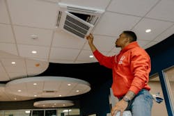 William Veal, HVAC journeyman at Pattman Plumbing, Heating and Air Conditioning, installs a filter cartridge in a Fujitsu AUU ceiling cassette unit. William Veal, HVAC journeyman at Pattman Plumbing, Heating and Air Conditioning, installs a filter cartridge in a Fujitsu AUU ceiling cassette unit.