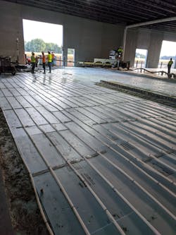 Each Uponor&rsquo;s Radiant Rollout Mat, factory preassembled for the project, was 150 feet long with three tubing loops; the Valor Mechanical crew installed 34 mats with 11 manifolds in the warehouse.