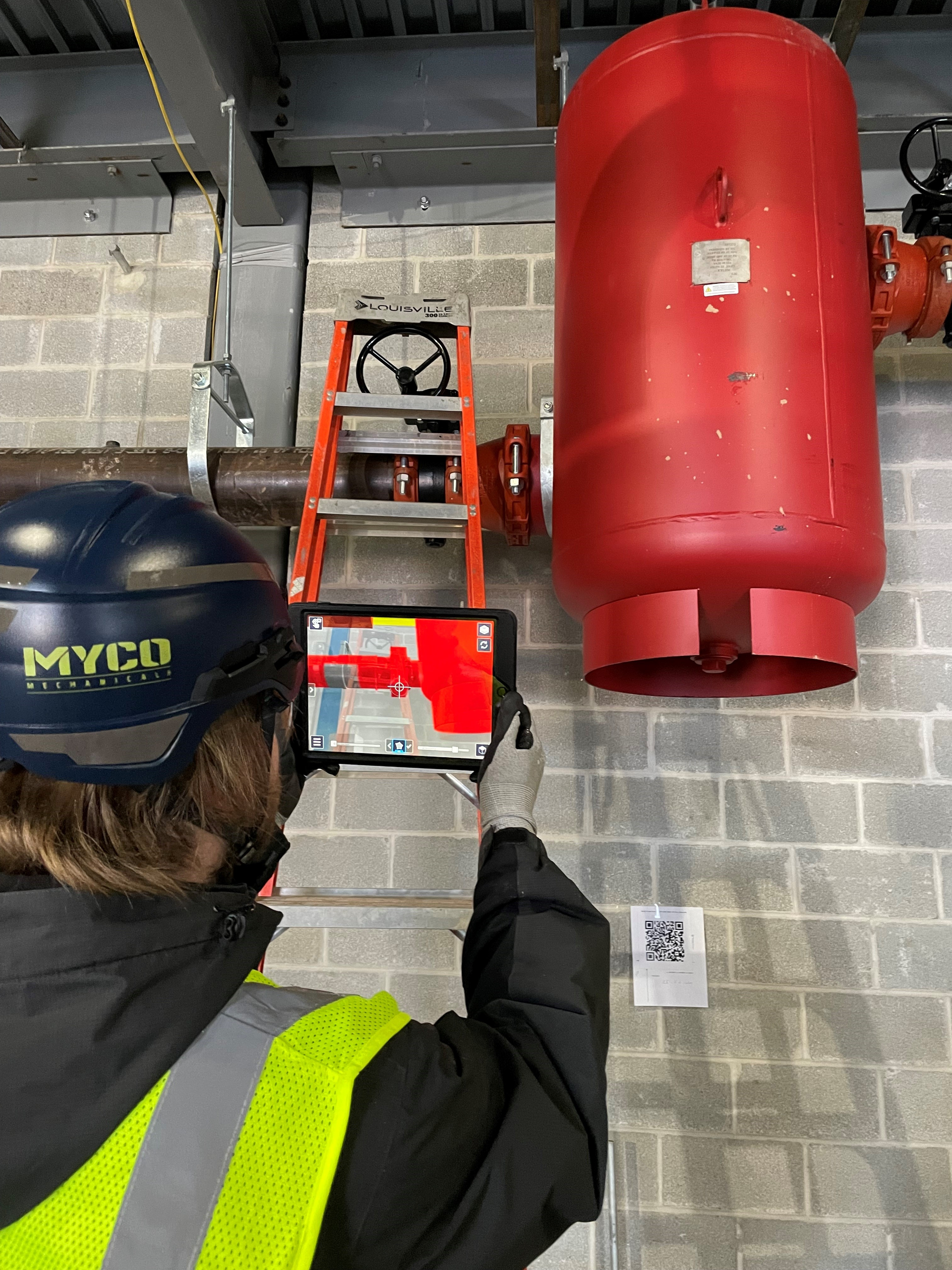 A Myco Mechanical technician verifies equipment placement using the Trimble AR system.