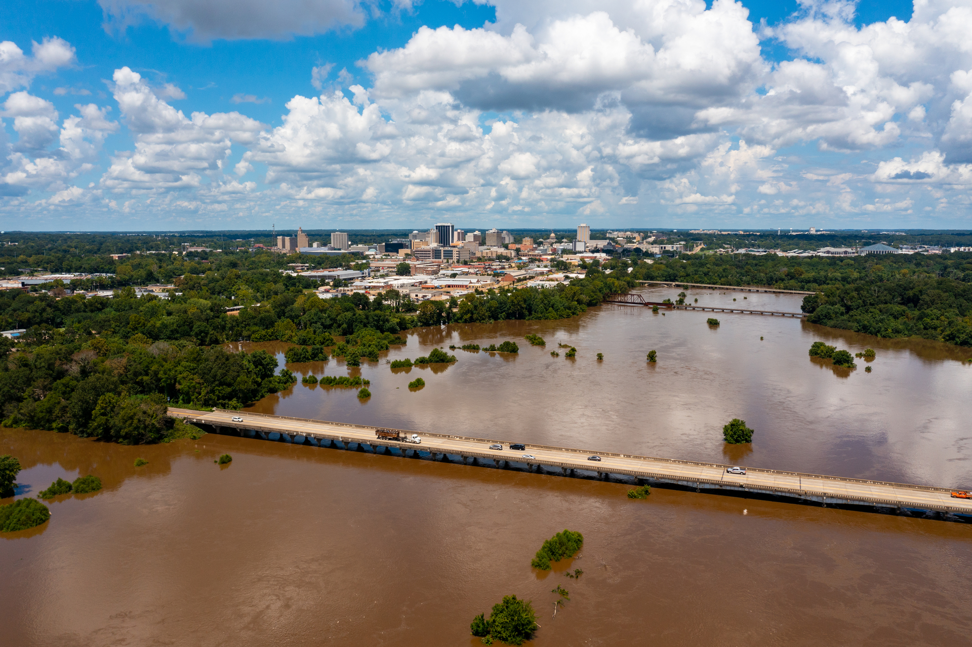 Jackson, MS Skyline with flooding Pearl River in the foreground in August 2022.