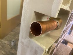 Side view of shower pan showing the side discharge shower body with brass pipe attached. Side view of shower pan showing the side discharge shower body with brass pipe attached.