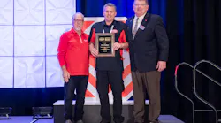 Paul Hallam (center) receives his award.