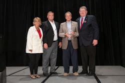 Chip Greene (holding award) and PHCC—National President Joel Long (far right). Chip Greene (holding award) and PHCC—National President Joel Long (far right).