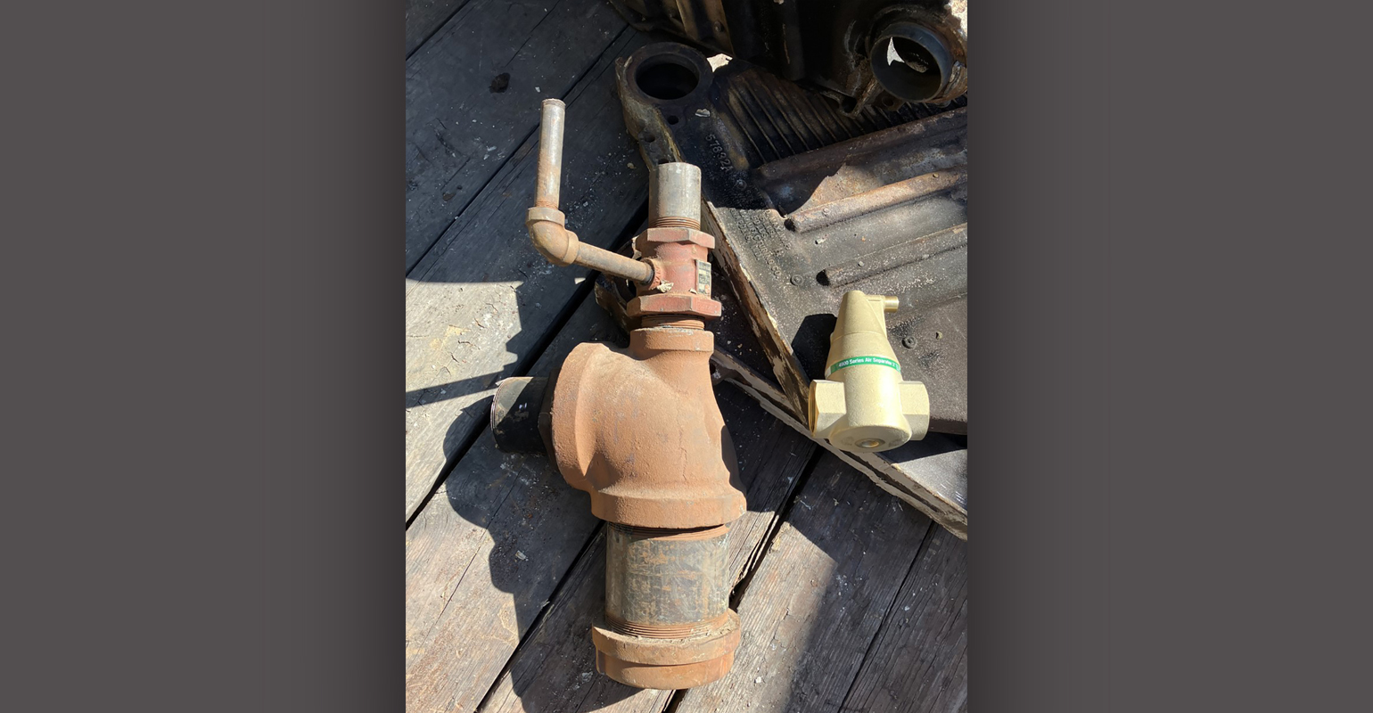 The red fitting on top of the very large tee is a Bell & Gossett dip tube air separator.