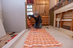 An installer laying out SunTouch radiant mats. An installer laying out SunTouch radiant mats.