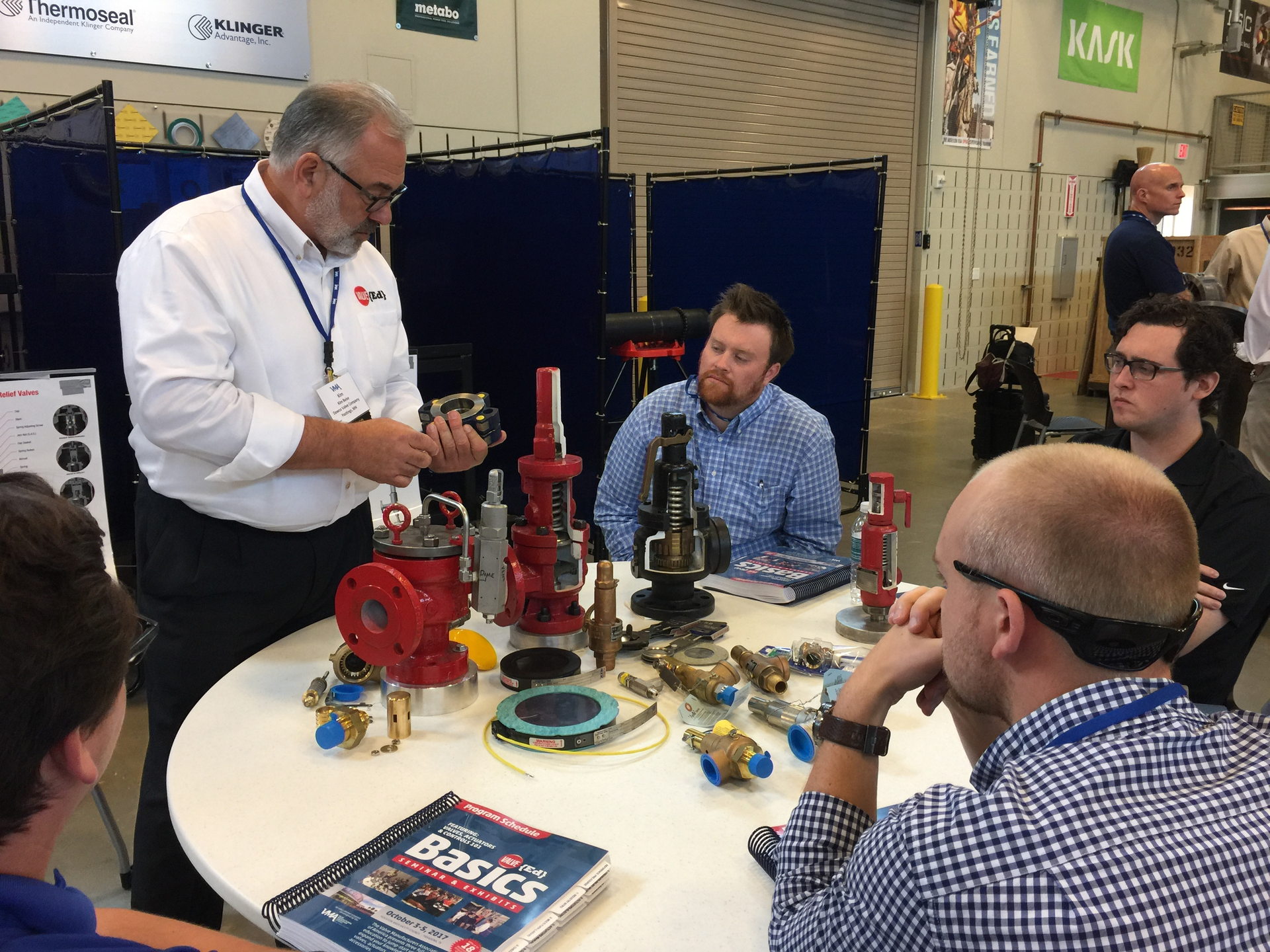 A presenter discuses the function of various valve components at a past Valve Basics Seminar and Petting Zoo.