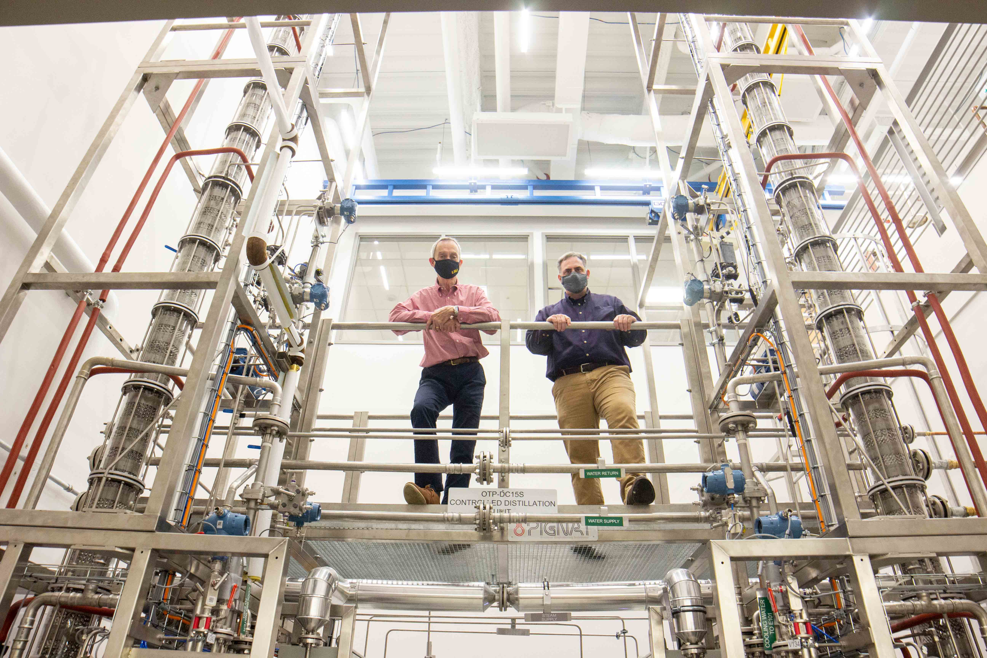 The new distillation columns with two LSU faculty members for scale.