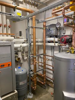 The carriage house mechanical room with the supply piping connected. The carriage house mechanical room with the supply piping connected.