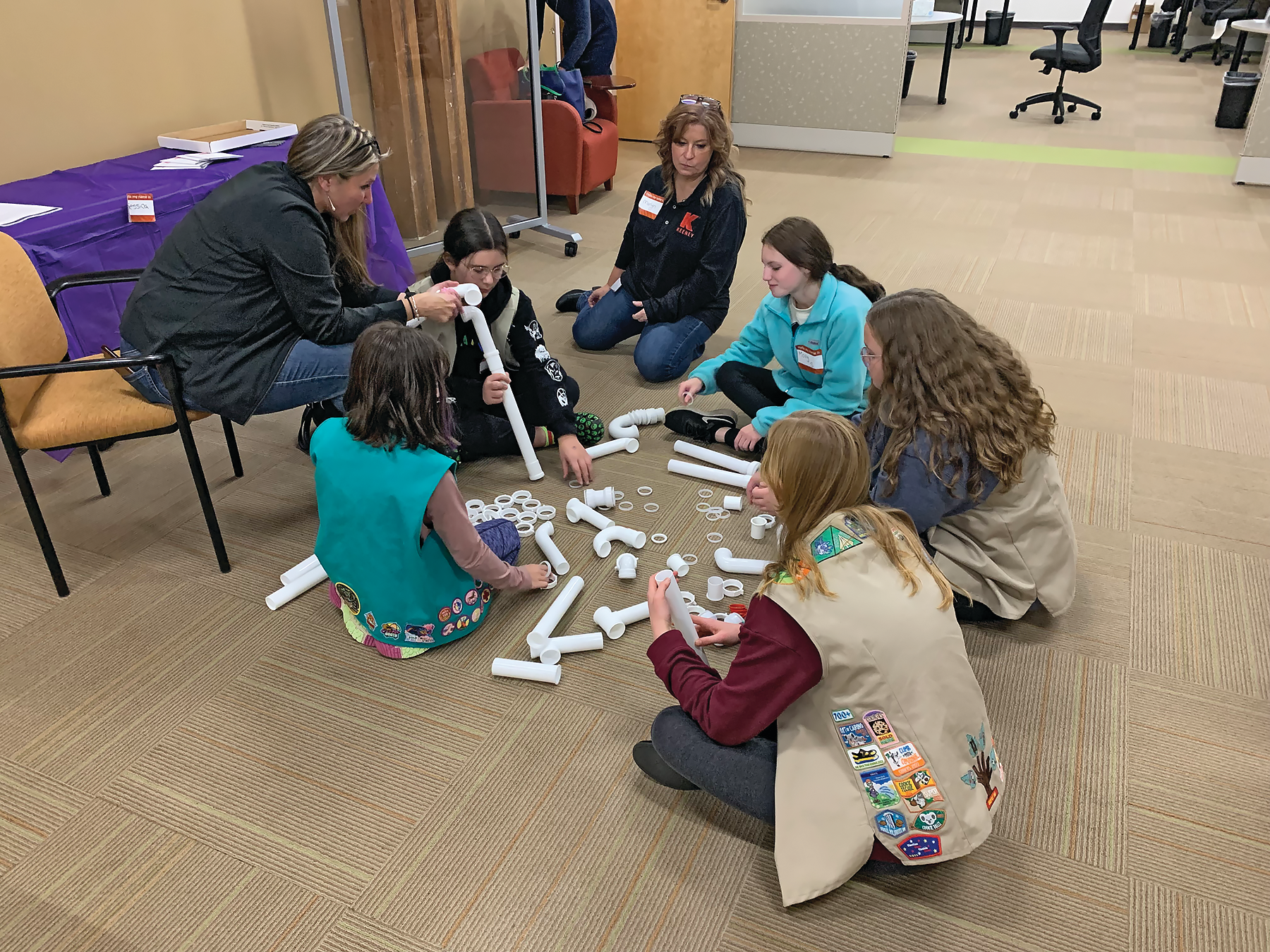 A hands-on plastic tubular engineering challenge, in which Girl Scouts applied problem solving skills to determine the most efficient way to move an object.