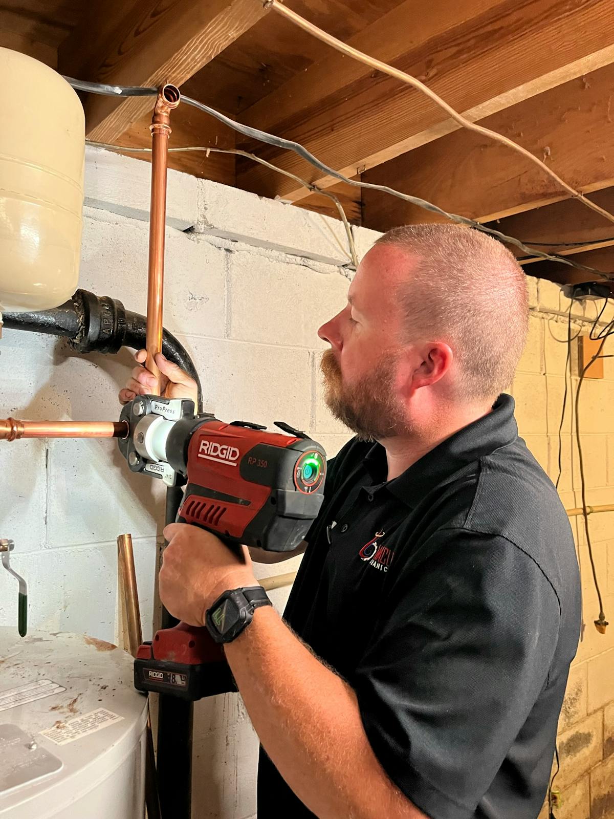 Brent Ridley works on a whole-house re-pipe project replacing corroded galvanized pipes with new copper piping and 80 lbs. of ProPress fittings donated by Viega.