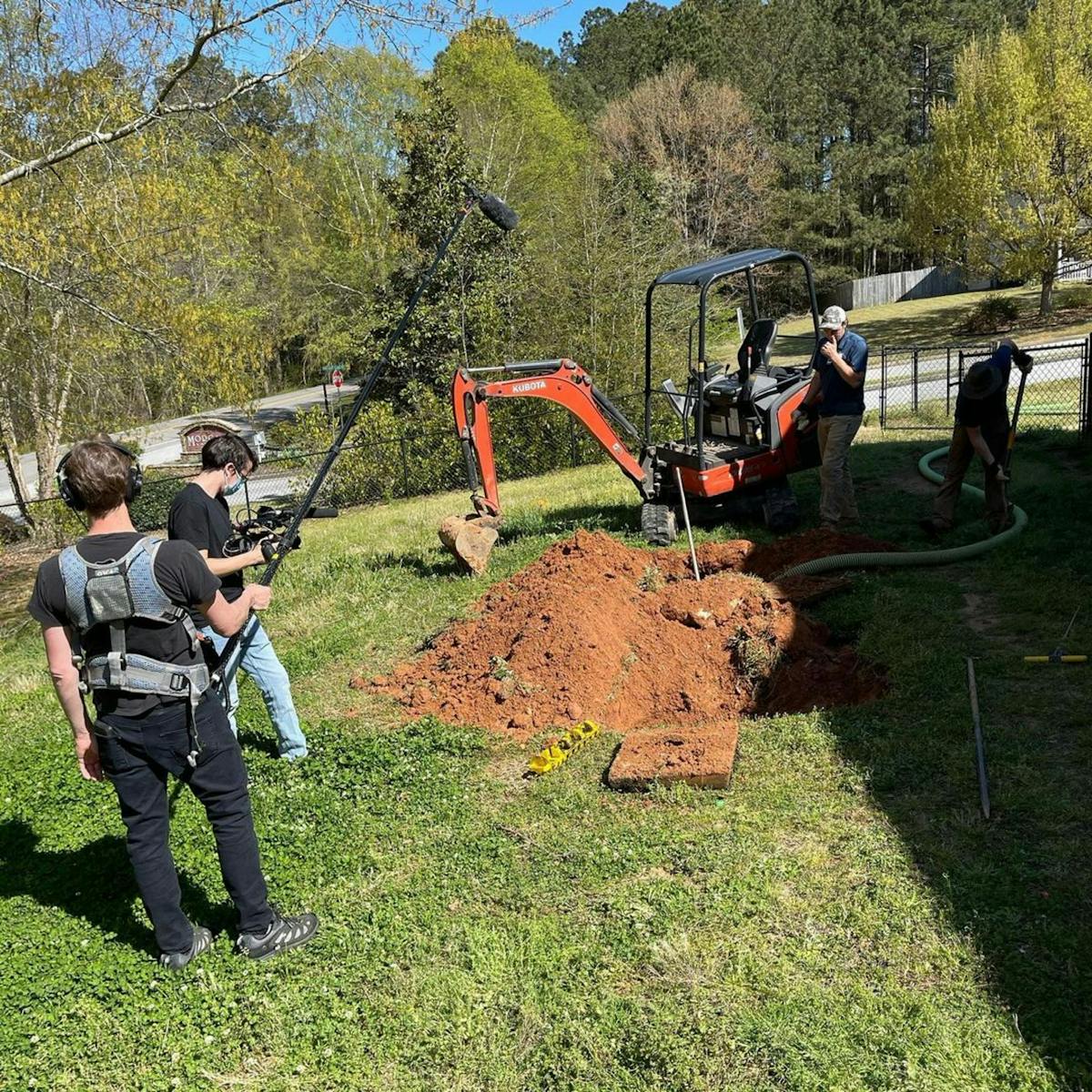 The team films some excavation work.