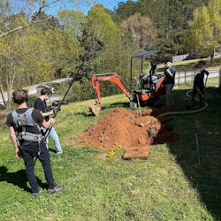 The team films some excavation work.