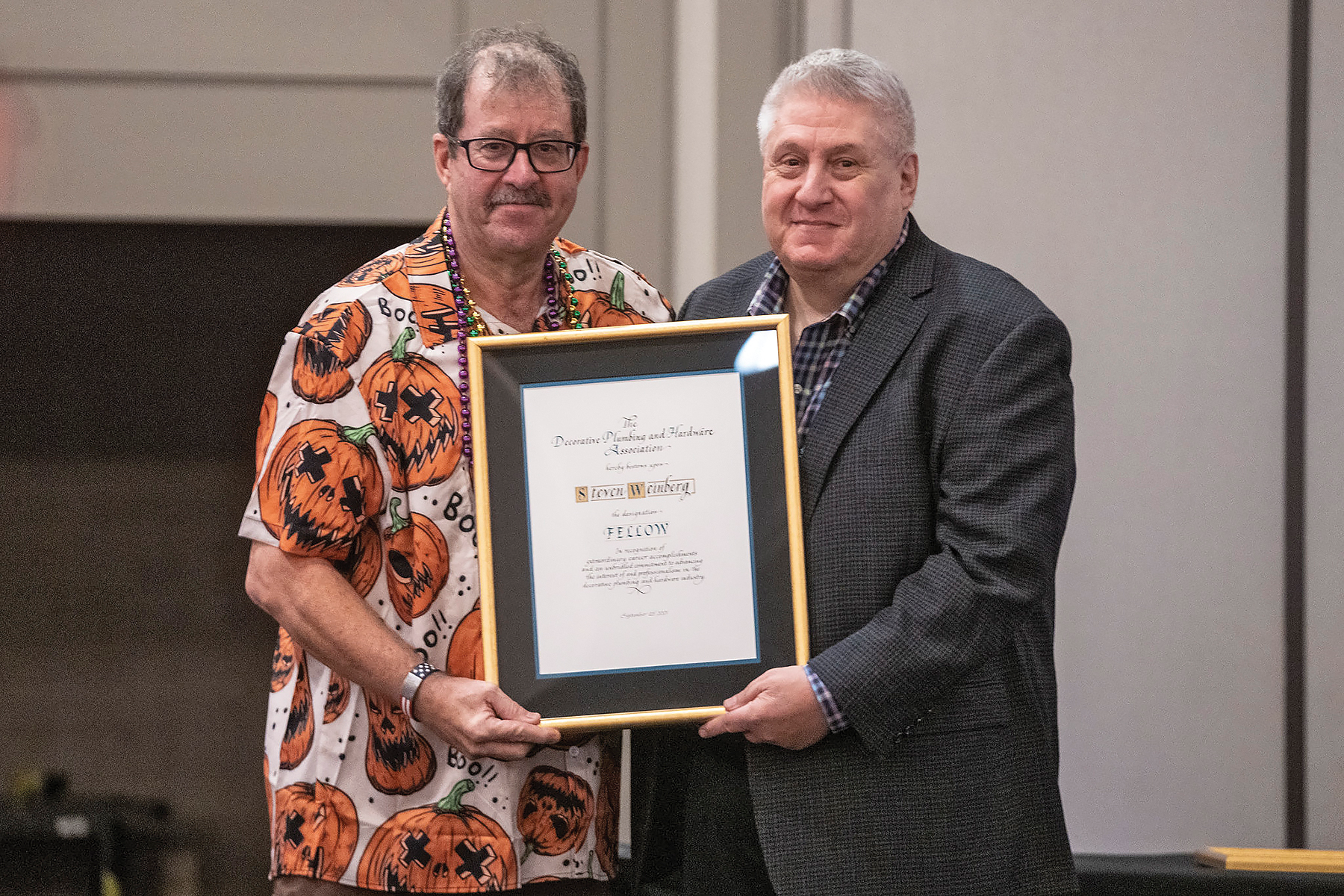 DPHA Emeritus Executive Director Jim Babbitt (L.) inducts Steven Weinberg (R.) into the DPHA Council of Fellows.