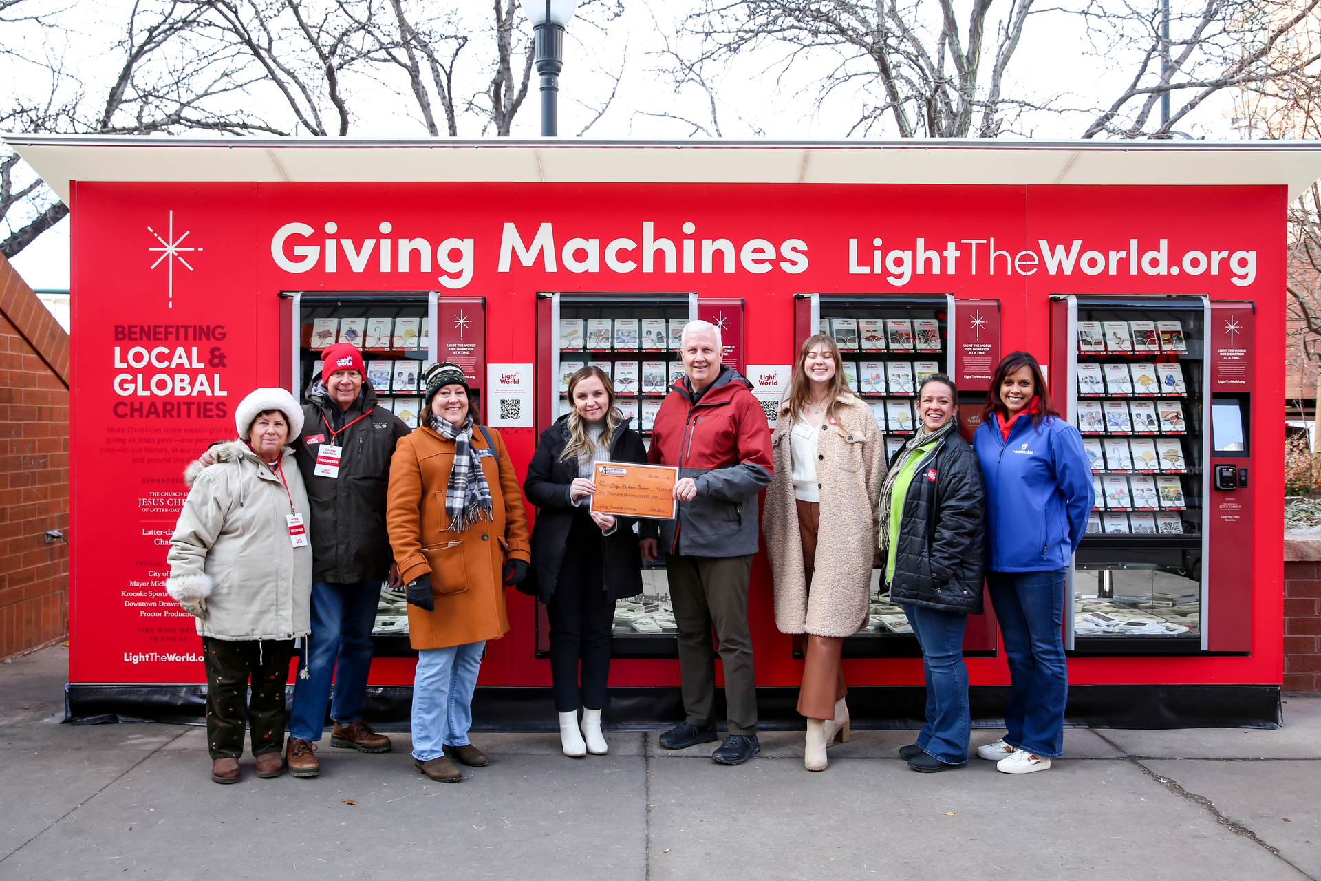 Giving Machines volunteers and representatives from Habitat for Humanity, Doctors Care and A Precious Child join Applewood Plumbing Heating & Electric to receive donation to Denver&rsquo;s Giving Machines.