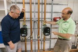 Two Taco 00e ECM pumps serve the space heating needs of a different wing of the school. Two Taco 00e ECM pumps serve the space heating needs of a different wing of the school.