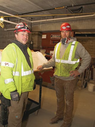 Major Mechanical plumbing foreman Pete Erny (left) and lead installer Jared Hudalla on the Applewood Pointe job site in November 2020.