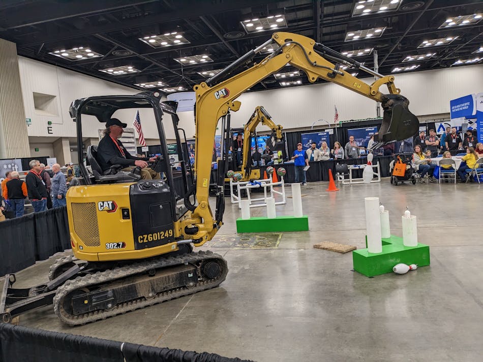 Competitors in the backhoe ROE-D-HOE show off their precision skills at the WWETT Show.