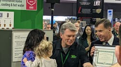 Dan Holohan (at right) presents the award to Hazen III's wife, Katelyn, and their daughter, Madison Marie at the 2023 AHR Expo. Dan Holohan (at right) presents the award to Hazen III's wife, Katelyn, and their daughter, Madison Marie at the 2023 AHR Expo.
