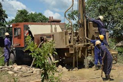 A well building team used a truck-mounted drill rig made by Atlas Corp. A well building team used a truck-mounted drill rig made by Atlas Corp.