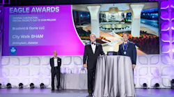 At the 2023 Eagle Awards, National Chair of the ABC Board of Directors Milton Graugnard (center) presents an award to Kyle McMullen of Brasfield and Gorrie while ABC Business Development Committee Chair Michael Barker (left) looks on.