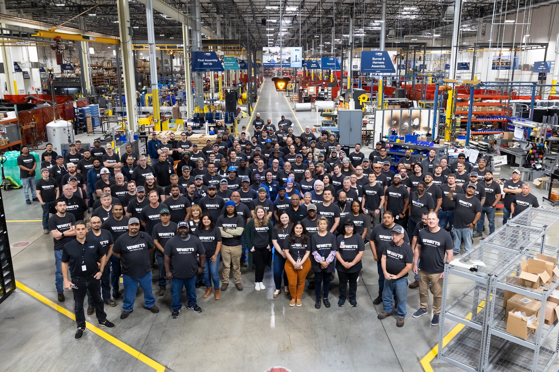Watts employees gathered on the production floor of the new facility.