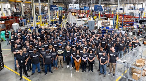 Watts employees gathered on the production floor of the new facility.
