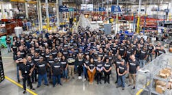 Watts employees gathered on the production floor of the new facility.