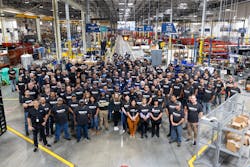 Watts employees gathered on the production floor of the new facility. Watts employees gathered on the production floor of the new facility.
