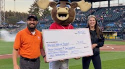 Steve Kochaniec from Harts Services presents a check on the field to Madison Strunk with the Wounded Warrior Project. Steve Kochaniec from Harts Services presents a check on the field to Madison Strunk with the Wounded Warrior Project.