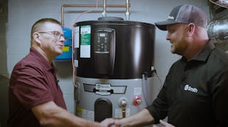 Gerry Winset of A.O. Smith (right) shakes hands with Carl (left), a tech working with W. L. Staton Plumbing, Cooling &amp; Heating, in front of a Voltex hybrid electric heat pump water heater.