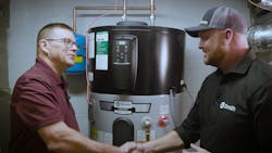 Gerry Winset of A.O. Smith (right) shakes hands with Carl (left), a tech working with W. L. Staton Plumbing, Cooling & Heating, in front of a Voltex hybrid electric heat pump water heater. Gerry Winset of A.O. Smith (right) shakes hands with Carl (left), a tech working with W. L. Staton Plumbing, Cooling & Heating, in front of a Voltex hybrid electric heat pump water heater.