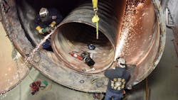 Boiler makers replacing the tubes and tube sheet in an industrial boiler. Boiler makers replacing the tubes and tube sheet in an industrial boiler.