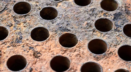 Mineral deposits, scale and corrosion on the plate of a heat exchanger.