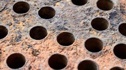 Mineral deposits, scale and corrosion on the plate of a heat exchanger. Mineral deposits, scale and corrosion on the plate of a heat exchanger.