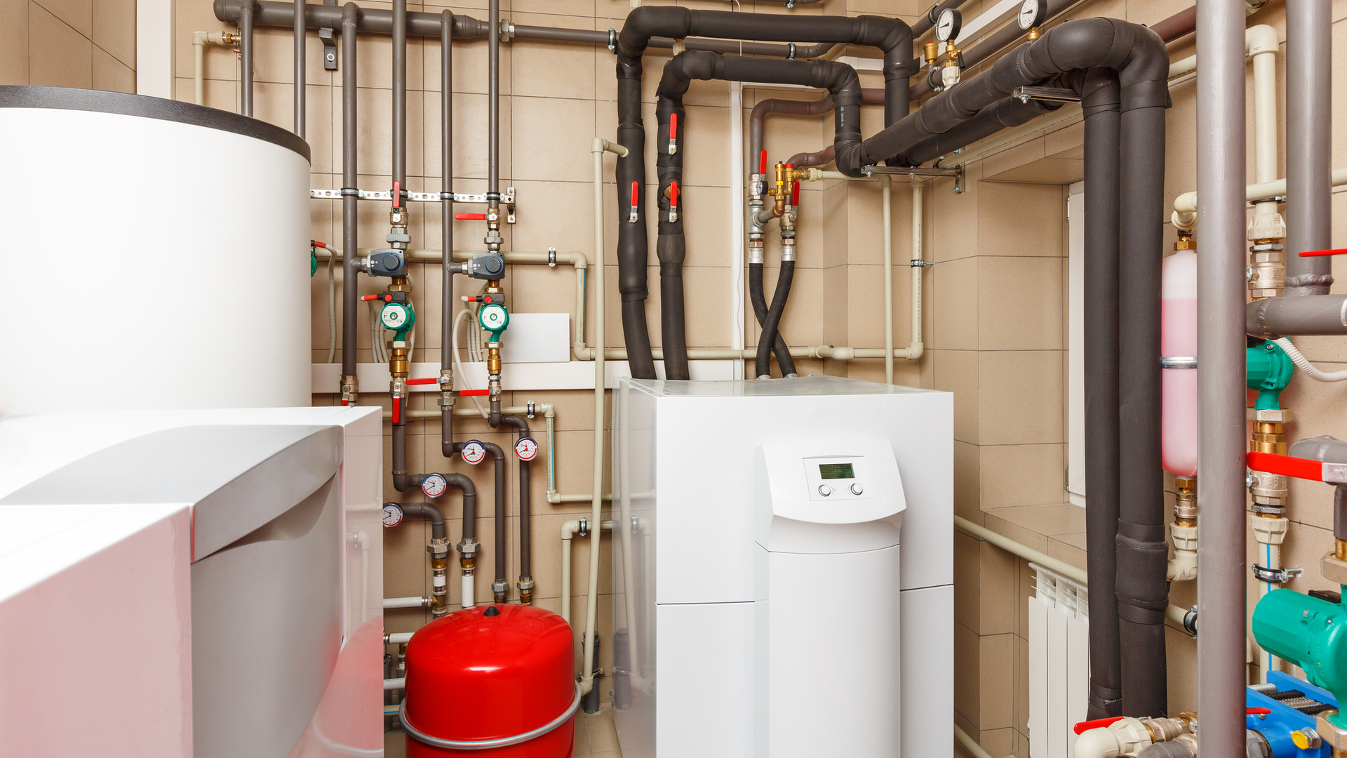 Household boiler room with heat pump, storage tank and circulators.