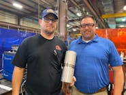 Shane Shook (left) and Robert Derby pose with a product of the new welding procedure.