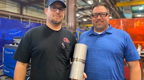 Shane Shook (left) and Robert Derby pose with a product of the new welding procedure.