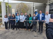 Uponor North America President Andres Caballero cuts the plastic pipe &apos;ribbon&apos; to open the company&apos;s new Experience Center.